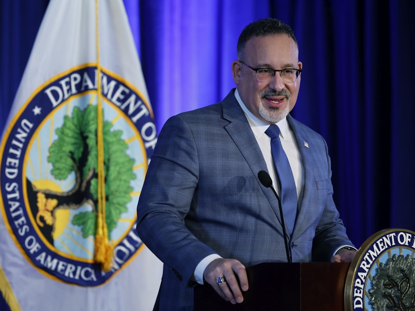 caption: "There is nothing valuable about being ripped off or sold on a worthless degree," U.S. Education Secretary Miguel Cardona said at a press briefing announcing the final rule. He is shown here in January 2022 in Washington, D.C.