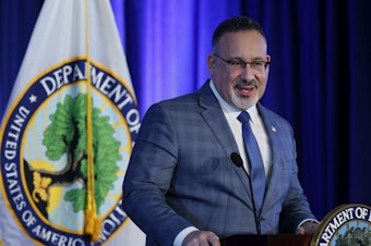 caption: "There is nothing valuable about being ripped off or sold on a worthless degree," U.S. Education Secretary Miguel Cardona said at a press briefing announcing the final rule. He is shown here in January 2022 in Washington, D.C.