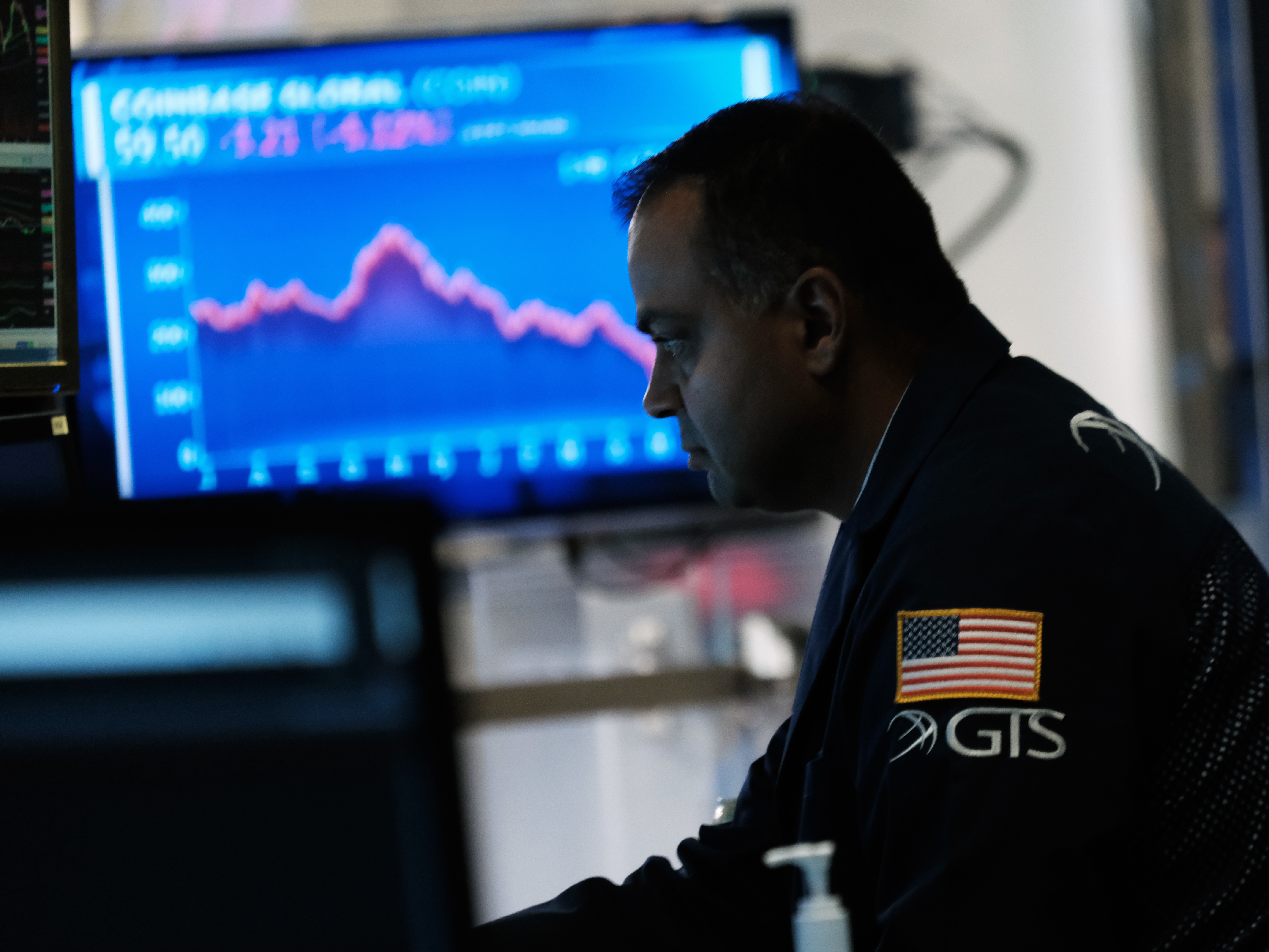 caption: Traders work on the floor of the New York Stock Exchange.