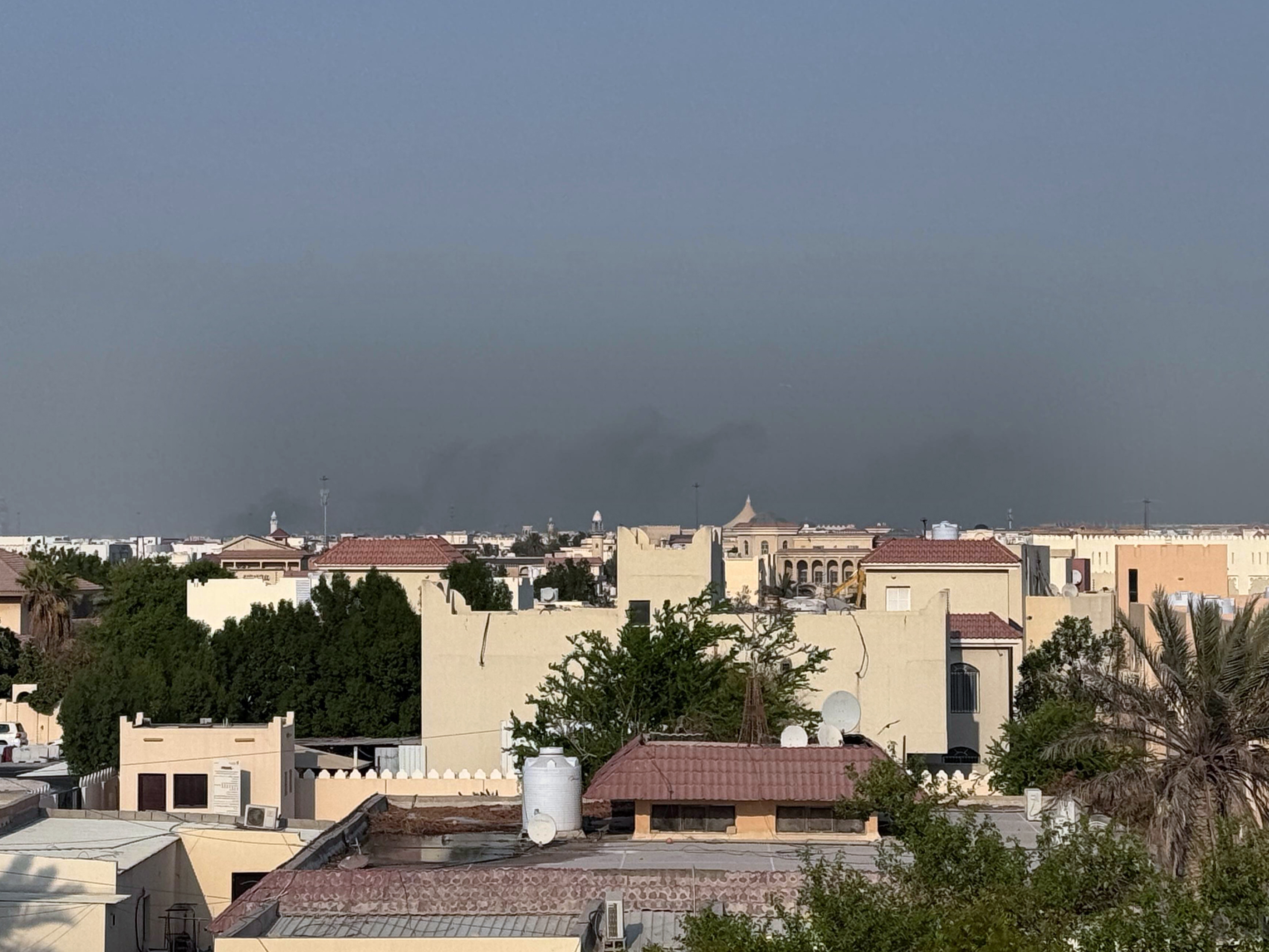 caption: Smoke rises from behind residential areas after explosions in Doha, Qatar, on Tuesday. Israel said it launched a strike targeting senior Hamas leaders.