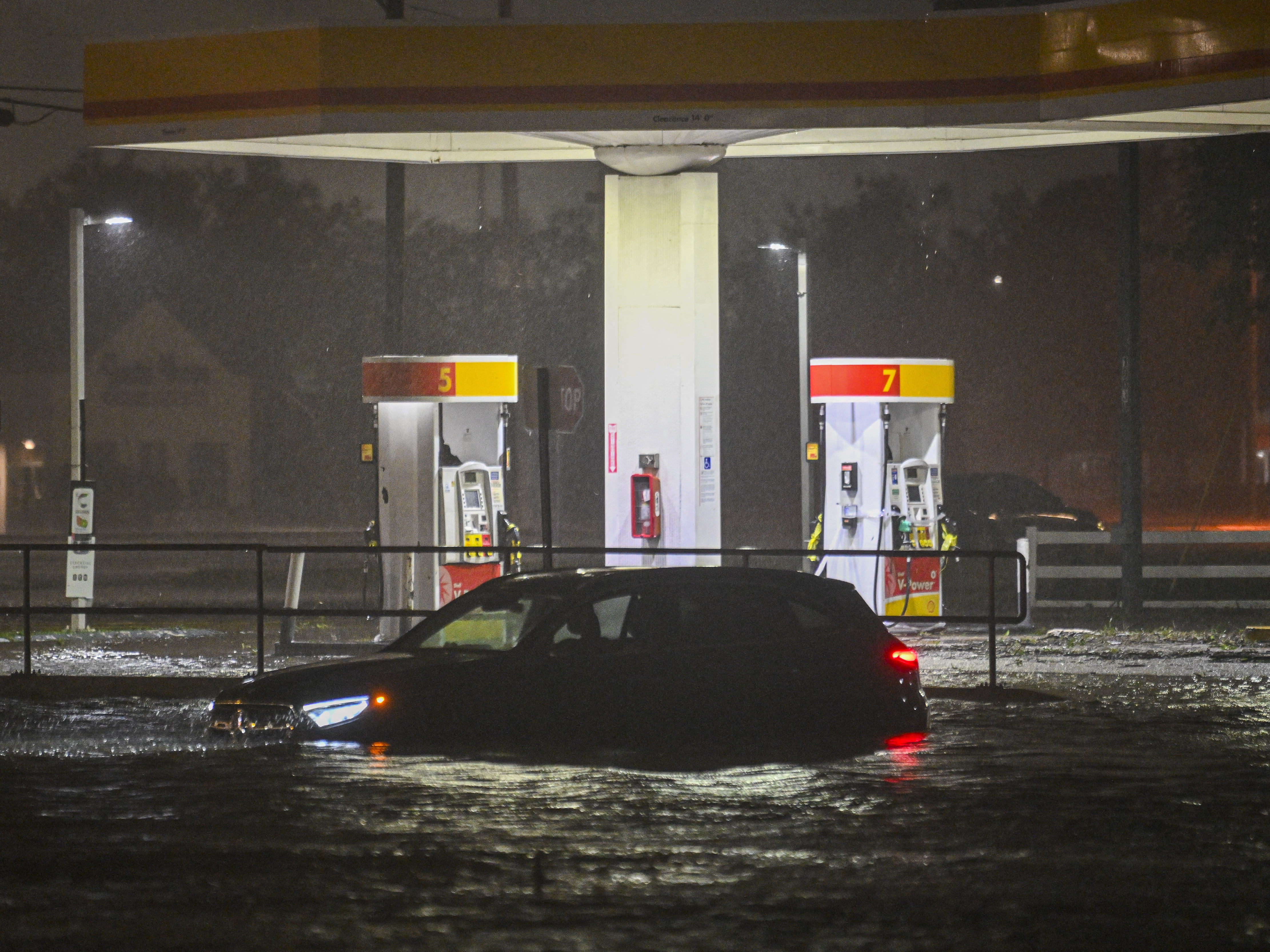 caption: A vehicle is stranded on a water-flooded street after Hurricane Milton made landfall in Brandon, Florida on Oct. 9, 2024.