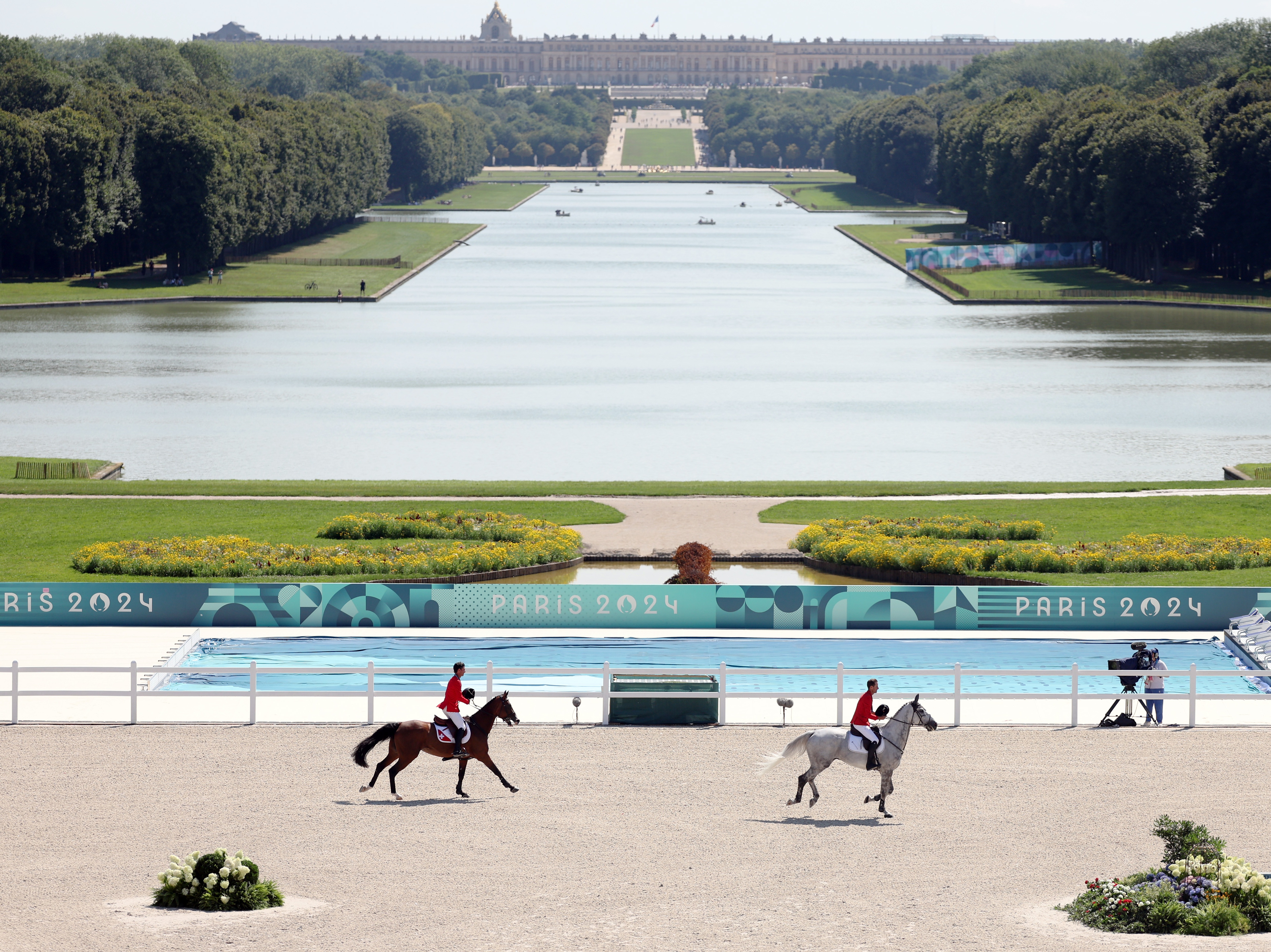 caption: The venue that hosted the Olympics equestrian events sits on the estate of Versailles, and the palace can be seen from the grandstand. 