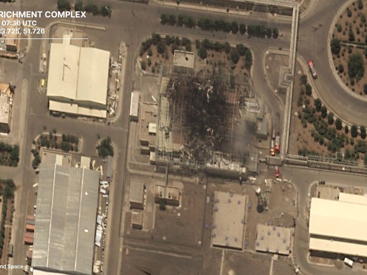 caption: A satellite photo from the European firm Airbus shows the aftermath of a strike by Israel on a building that houses centrifuges at Iran's Natanz nuclear facility.