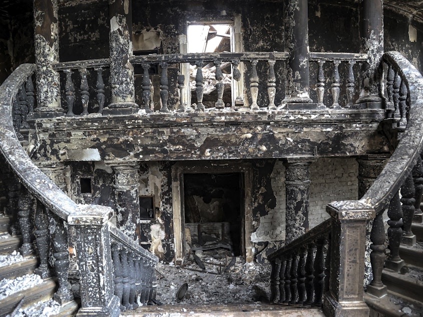 caption: Debris covers the inside of the drama theater in April following a March 16 bombing in Mariupol, Ukraine, in an area now controlled by Russian forces.