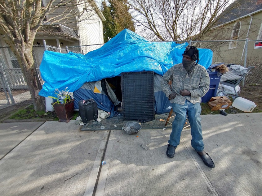 caption: Tony Nelson outside his tent on MLK in Tacoma's Hilltop neighborhood.