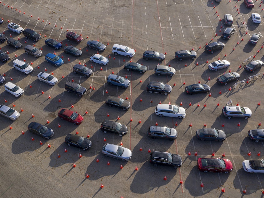 caption: In an aerial view from a drone, cars line up at Dodger Stadium for COVID-19 testing in Los Angeles, California.