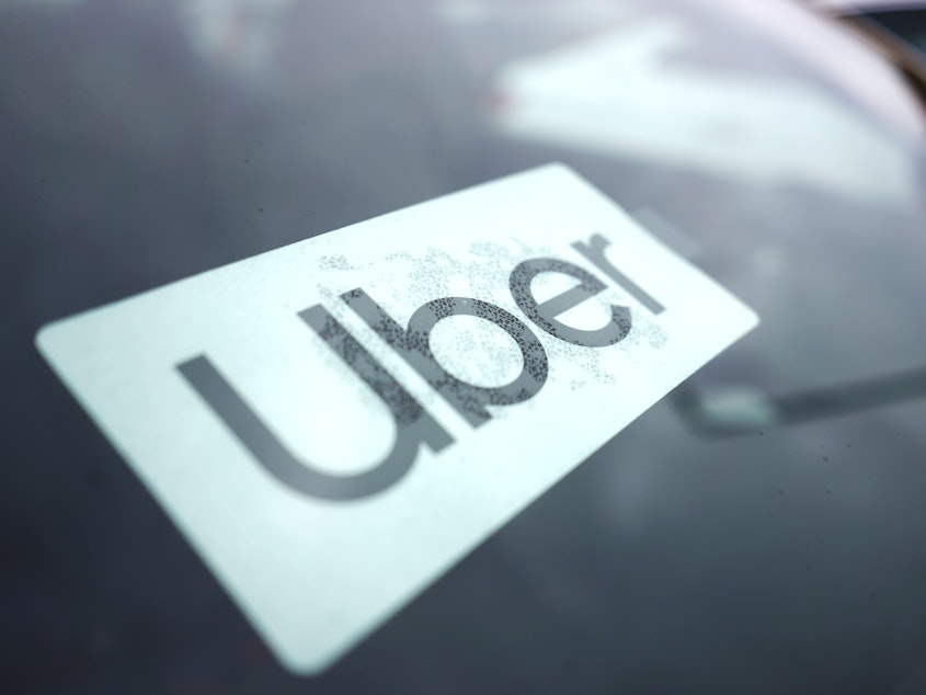caption: An Uber sign is displayed inside a car in Palatine, Ill., Thursday, Feb. 10, 2022.