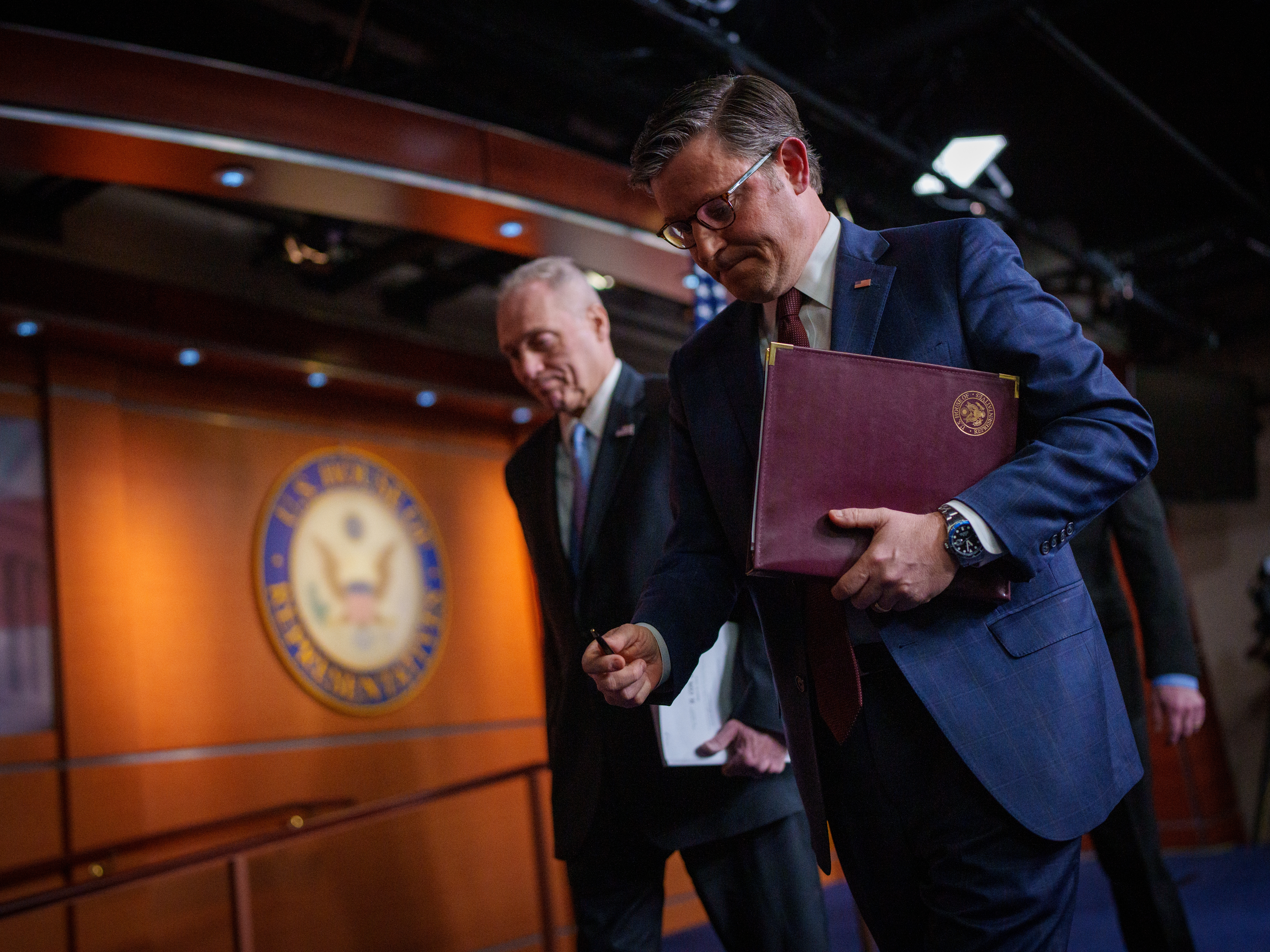 caption: Speaker of the House Mike Johnson, R-La., (right) departs a news conference alongside House Majority Leader Steve Scalise, R-La., at the U.S. Capitol on Tuesday. House Republicans are working to pass a budget bill this week that includes up to $4.5 trillion in tax cuts and an increase in the debt limit.