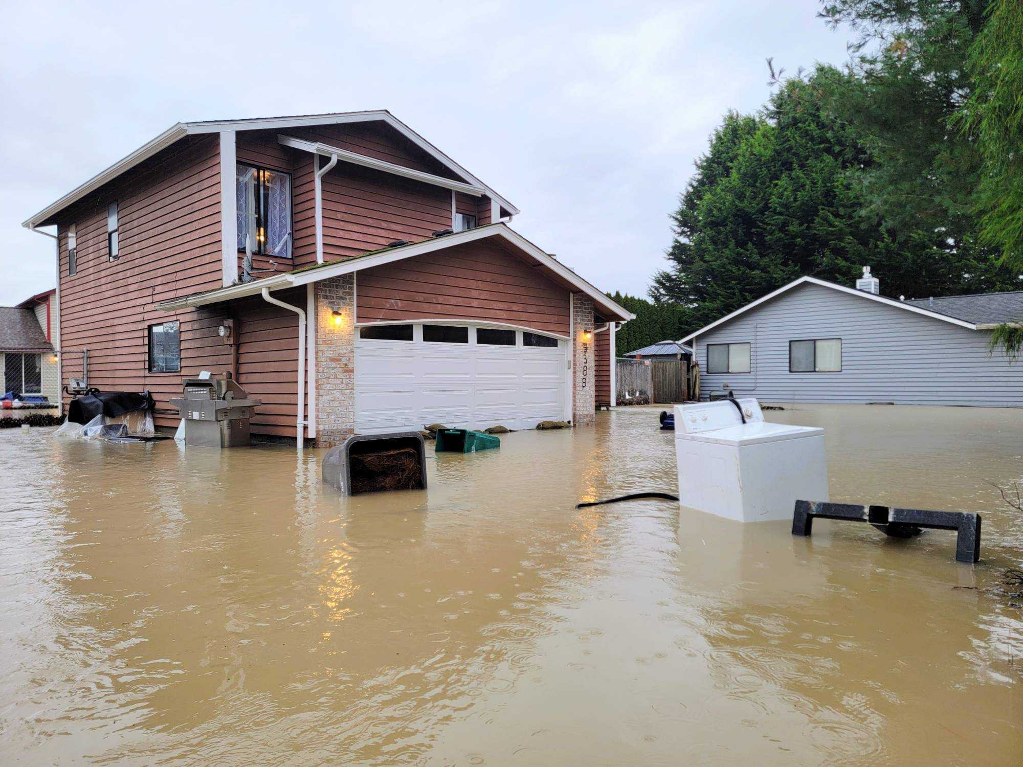 caption: A flooded home in the south King County community of Pacific on Tuesday, Dec. 16, 2025.