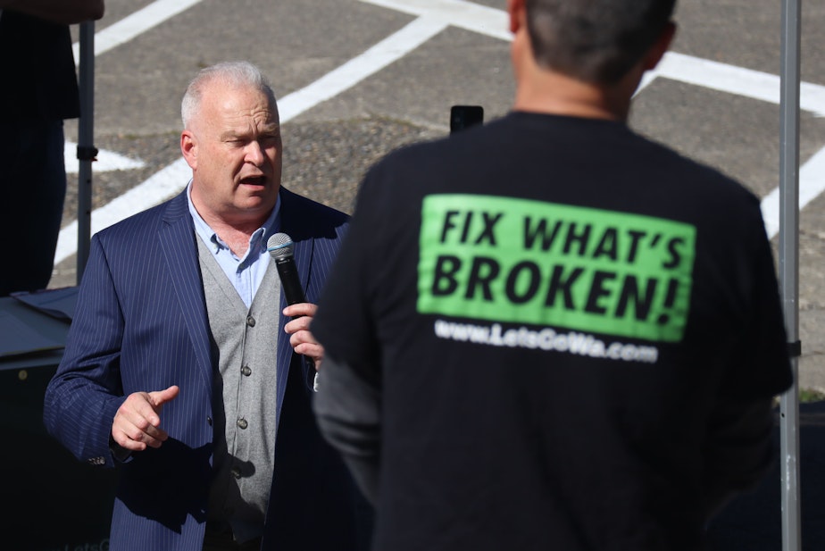 caption: Jim Walsh, a state representative and chair of the Washington State Republican Party speaks at an event on the capitol steps Thursday, June 6, 2024. Walsh sponsored the voter initiatives that are heading to ballots this fall and was one of the plaintiffs in the lawsuit.