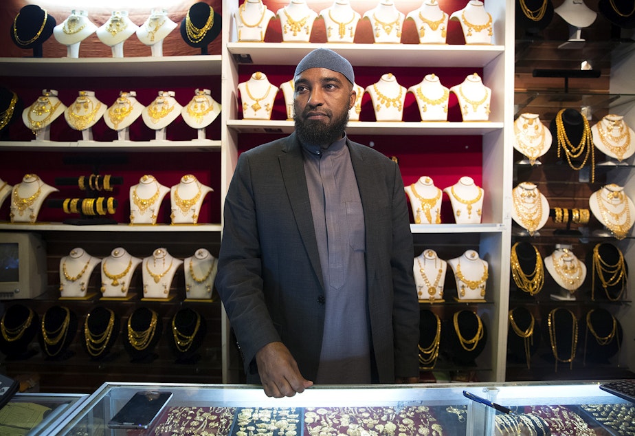 Ali Jama stands behind the counter of Haveniceday Jewelry on Thursday, April 19, 2018, in Tukwila.