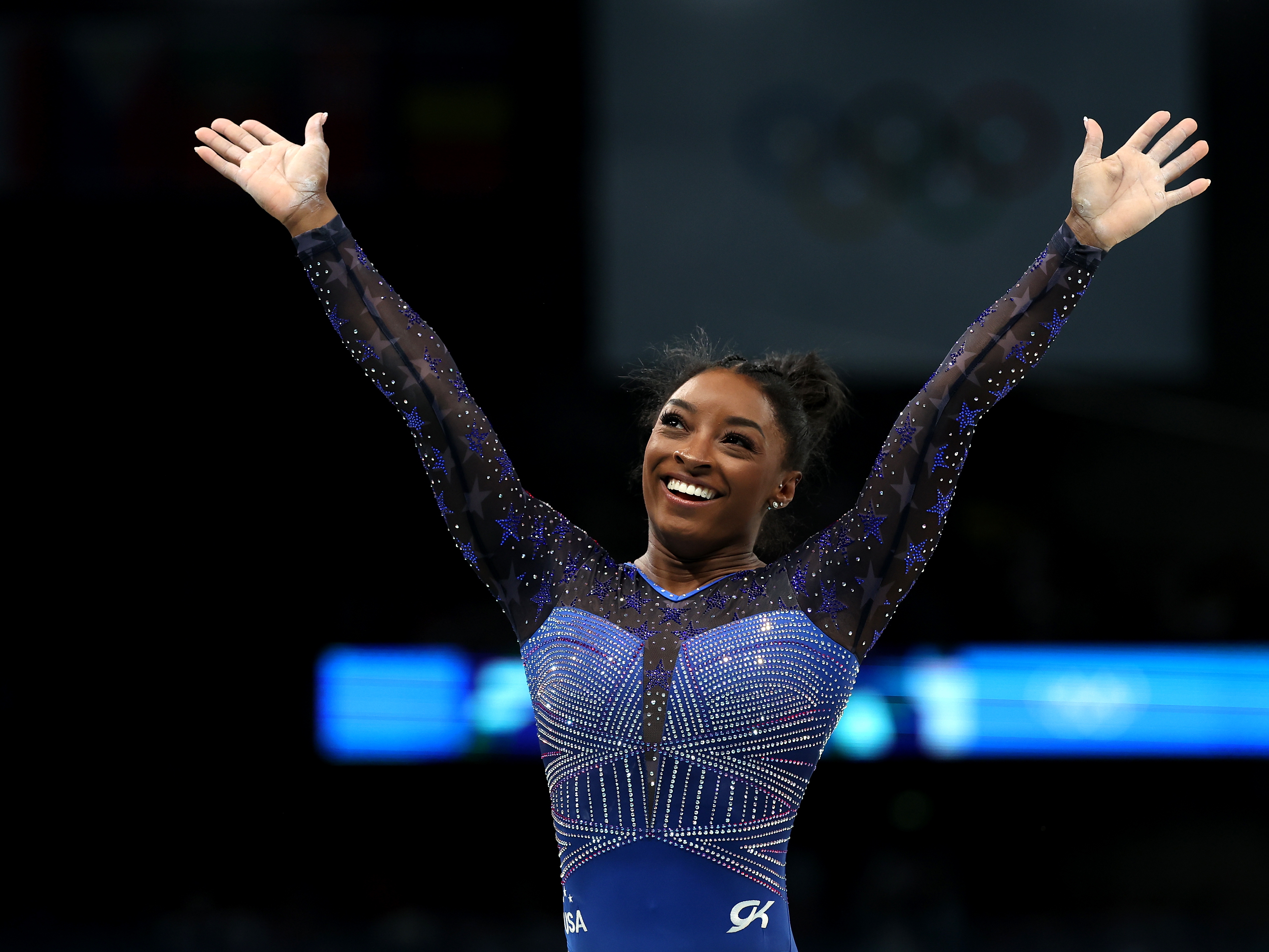 caption: Simone Biles reacts after the balance beam portion of the women's gymnastics individual all-around competition at the Paris Olympics on Thursday. She's now won six Olympic gold medals — the most of any U.S. gymnast.