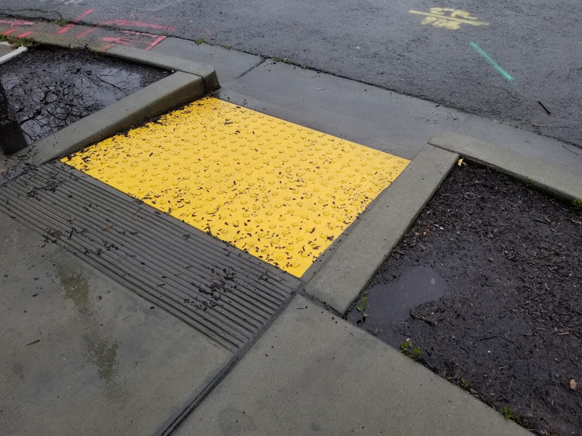 caption: A curb cut, one piece of accessible infrastructure 