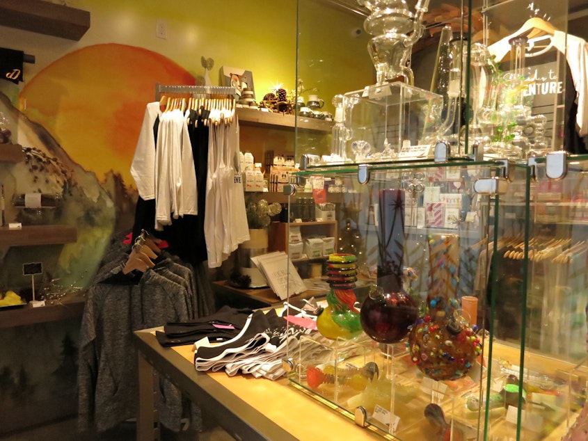 caption: A glass case holds bongs, pipes, and other marijuana paraphernalia at the Canna West Culture Shop in West Seattle.
