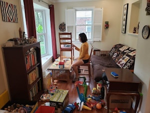 caption: Gretchen Goldman shared this behind-the-scenes photo on Twitter of what it's like to work from home and parent during the pandemic.