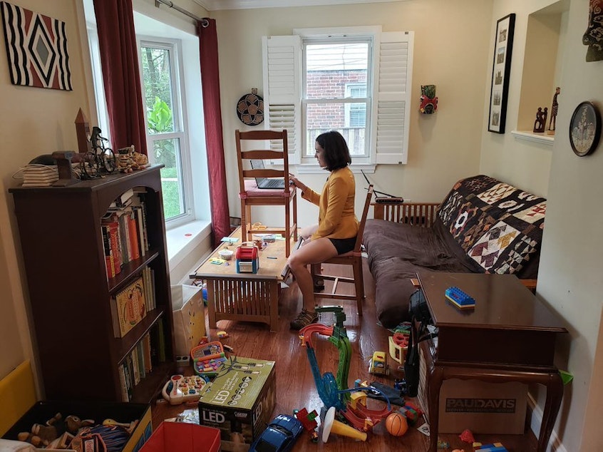 caption: Gretchen Goldman shared this behind-the-scenes photo on Twitter of what it's like to work from home and parent during the pandemic.