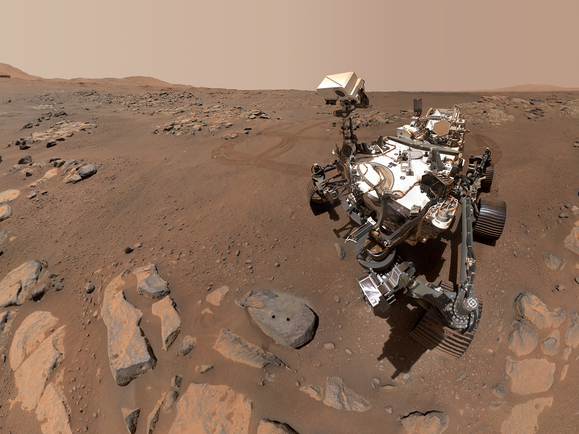 caption: NASA's Perseverance rover took this photo next to a rock where it drilled for samples. NASA wants to bring samples collected by this rover back to Earth.