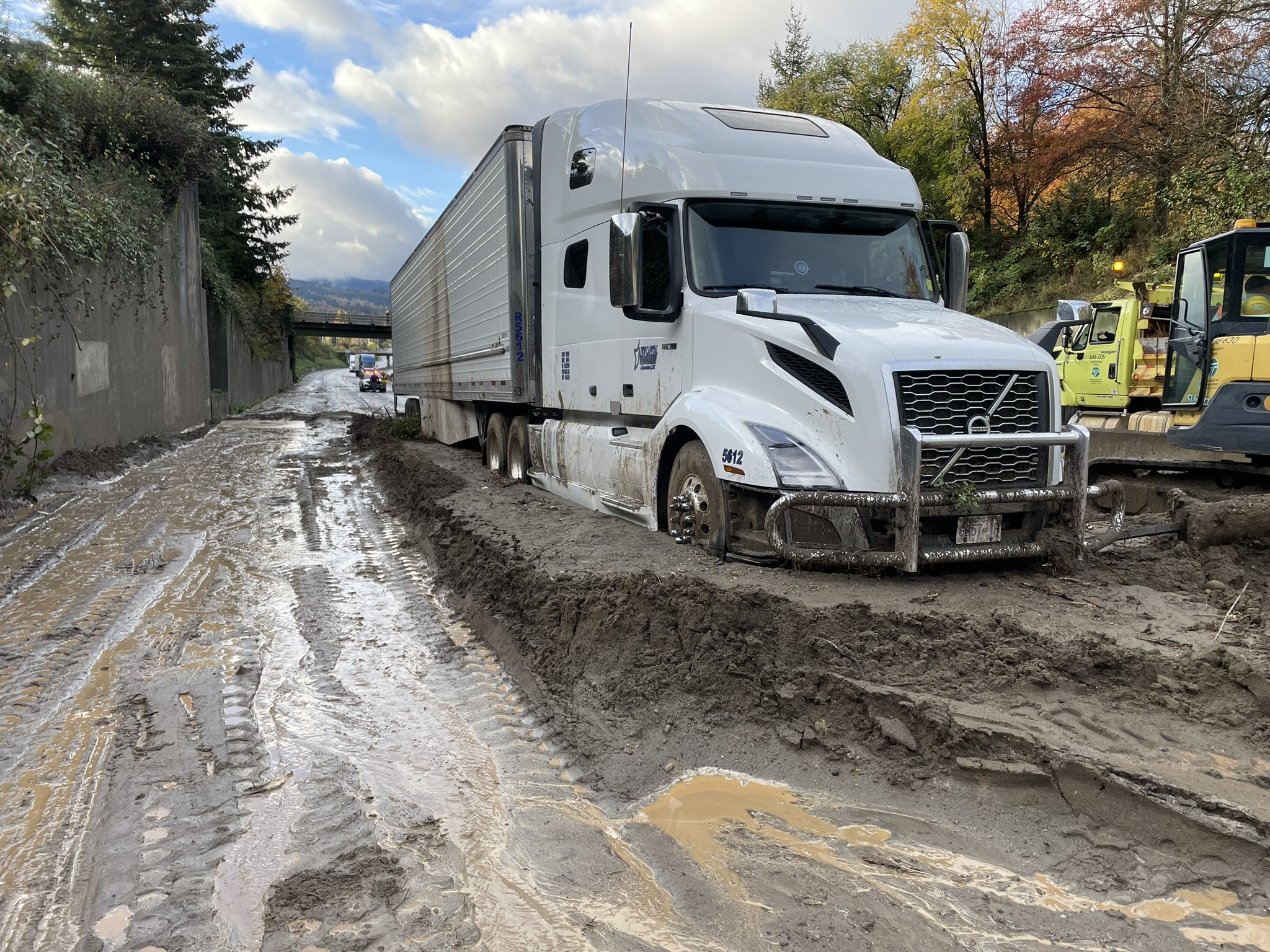 caption: A truck sits stuck in mud on northbound Interstate 5 in Bellingham, Washington, on Oct. 27, 2024.