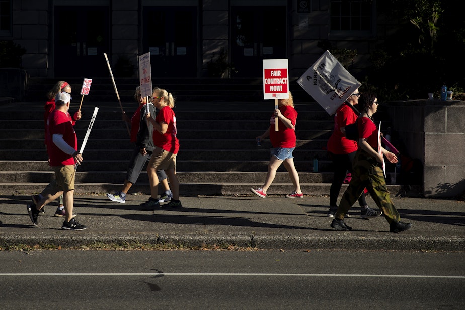 caption: Seattle Public Schools educators walk the picket line on Thursday, September 8, 2022, outside of the Salmon Bay School on Northwest 65th Street in Seattle.