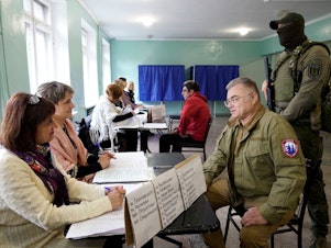 caption: Konstantin Ivashchenko, former CEO of the Azovmash plant and appointed pro-Russian mayor of Mariupol, visits a polling station as people vote in a referendum in Mariupol on Tuesday.