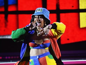 caption: Cardi B performs onstage during the 2018 Grammy Awards.