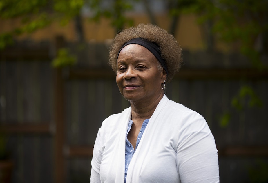 caption: Joyce Epps stands for a portrait in the backyard of her home on Tuesday, May 10, 2022, in Renton. 