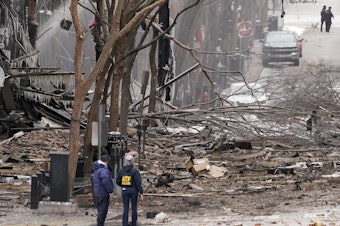 caption: Emergency personnel work near the scene of an explosion in downtown Nashville, Tenn., on Dec. 25.