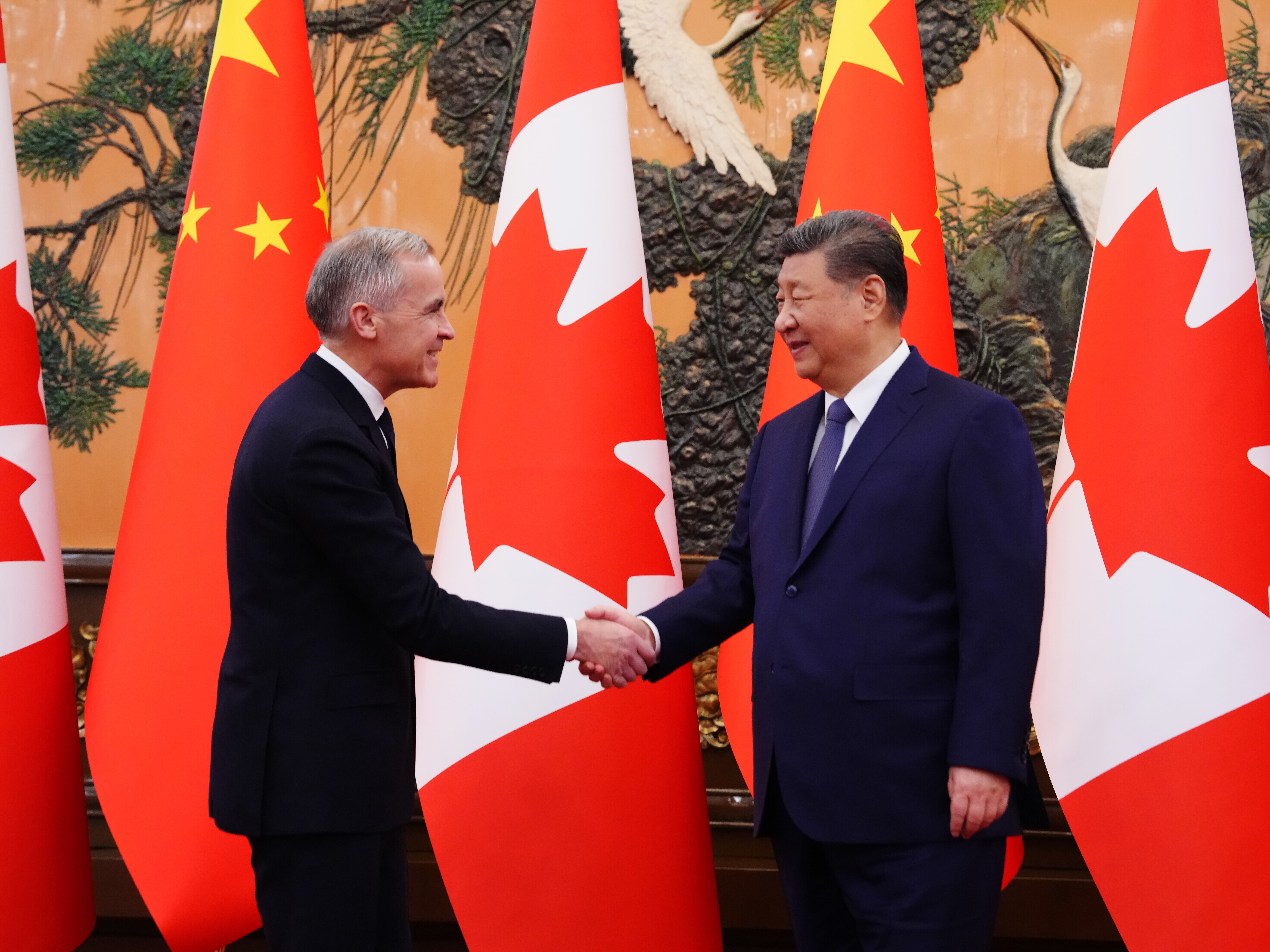caption: Canada's Prime Minister Mark Carney, left, meets with Chinese President Xi Jinping at the Great Hall of the People in Beijing Friday, Jan. 16, 2026.