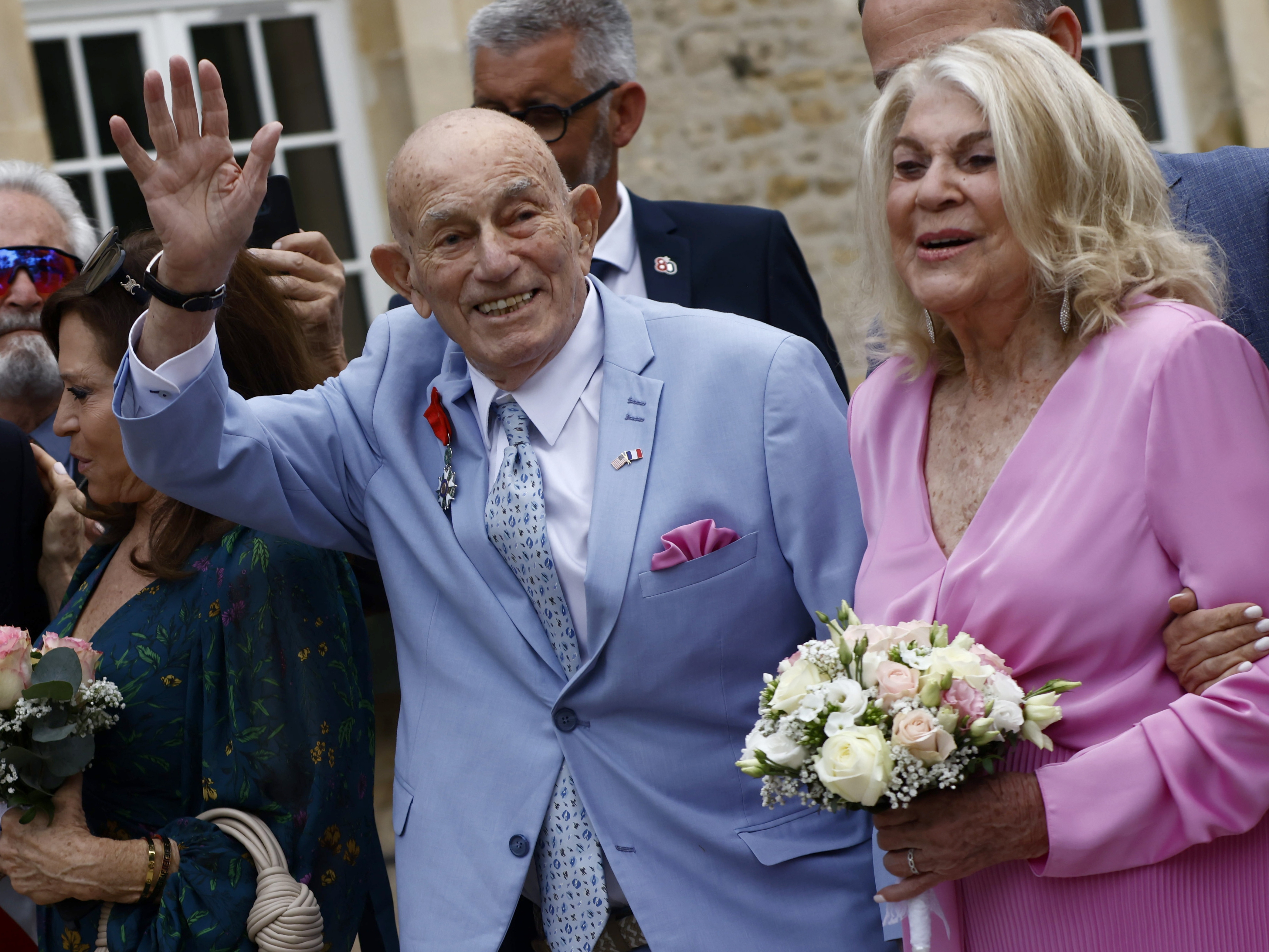 caption: U.S. World War II veteran Harold Terens, 100, left, and Jeanne Swerlin, 96, arrive to celebrate their wedding at the town hall of Carentan-les-Marais, in Normandy, northwestern France, on Saturday.
