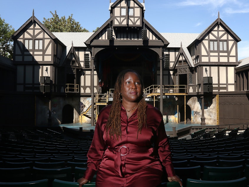 caption: Oregon Shakespeare Festival Artistic Director Nataki Garrett stands inside the Allen Elizabethan Theatre in Ashland, Ore. She recently programmed her first full season but not everyone has embraced her new approach.
