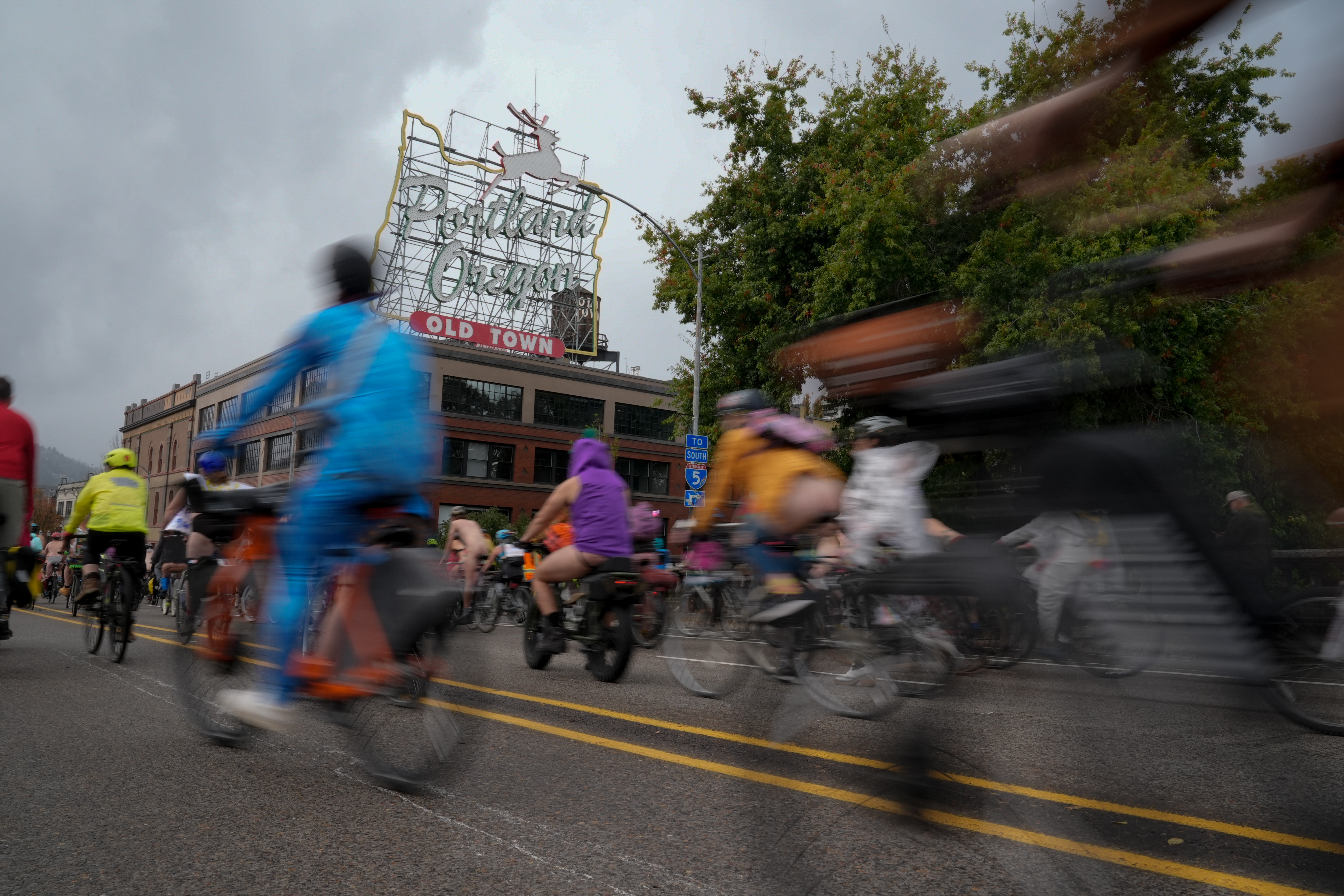 caption: Cyclists in the Naked Bike Ride in downtown Portland, Oregon, in protest of Donald Trump's attempts to mobilize the National Guard, Sunday, Oct. 12, 2025. 