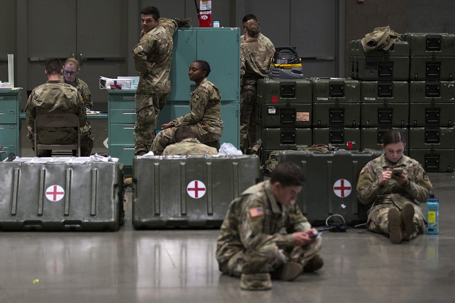 caption: U.S. Army soldiers are shown in the lab area of a military field hospital being deployed by soldiers from the 627th Army Hospital from Fort Carson, Colorado, along with soldiers from Joint Base Lewis-McChord on Tuesday, March 31, 2020, at the CenturyLink Field Event Center in Seattle. The 250-bed hospital will be for non COVID-19 patients. 