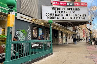 caption: The marquee of the IFC Center in Manhattan welcomes viewers back after being closed nearly one year