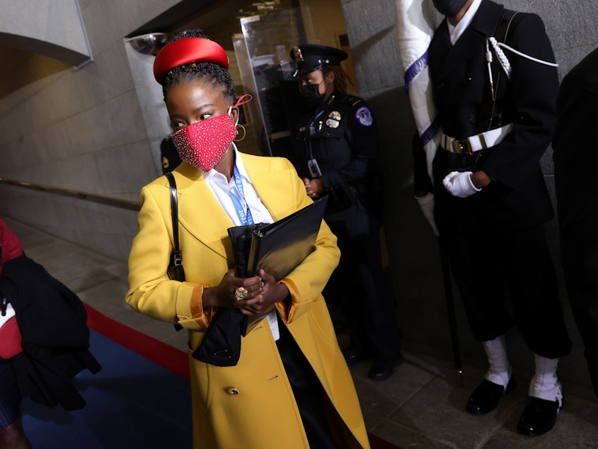 caption: Former National Youth Poet Laureate Amanda Gorman arrives at the inauguration of US President-elect Joe Biden on the West Front of the US Capitol on Jan. 20 in Washington, D.C. Gorman says she was tailed Friday night by a security guard who said she looked "suspicious."
