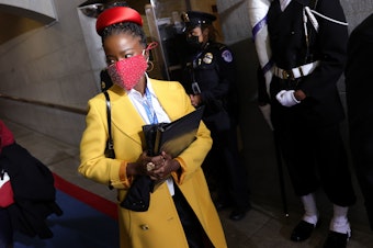 caption: Former National Youth Poet Laureate Amanda Gorman arrives at the inauguration of US President-elect Joe Biden on the West Front of the US Capitol on Jan. 20 in Washington, D.C. Gorman says she was tailed Friday night by a security guard who said she looked "suspicious."