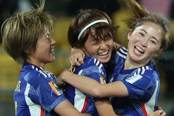 caption: Japanese midfielder Hinata Miyazawa, center, celebrates after scoring her team's third goal during its match against Spain earlier this week. Japan is one of three teams to win all its games in the group stage.
