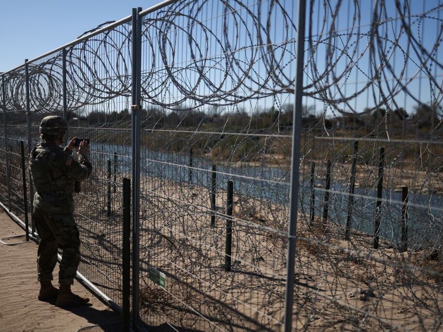 caption: A U.S. Army soldier monitors the border with Mexico in Eagle Pass, Texas, last week. President Trump ordered 1,500 more active military personnel to the southern border, part of a broad immigration crackdown during his first week in office.