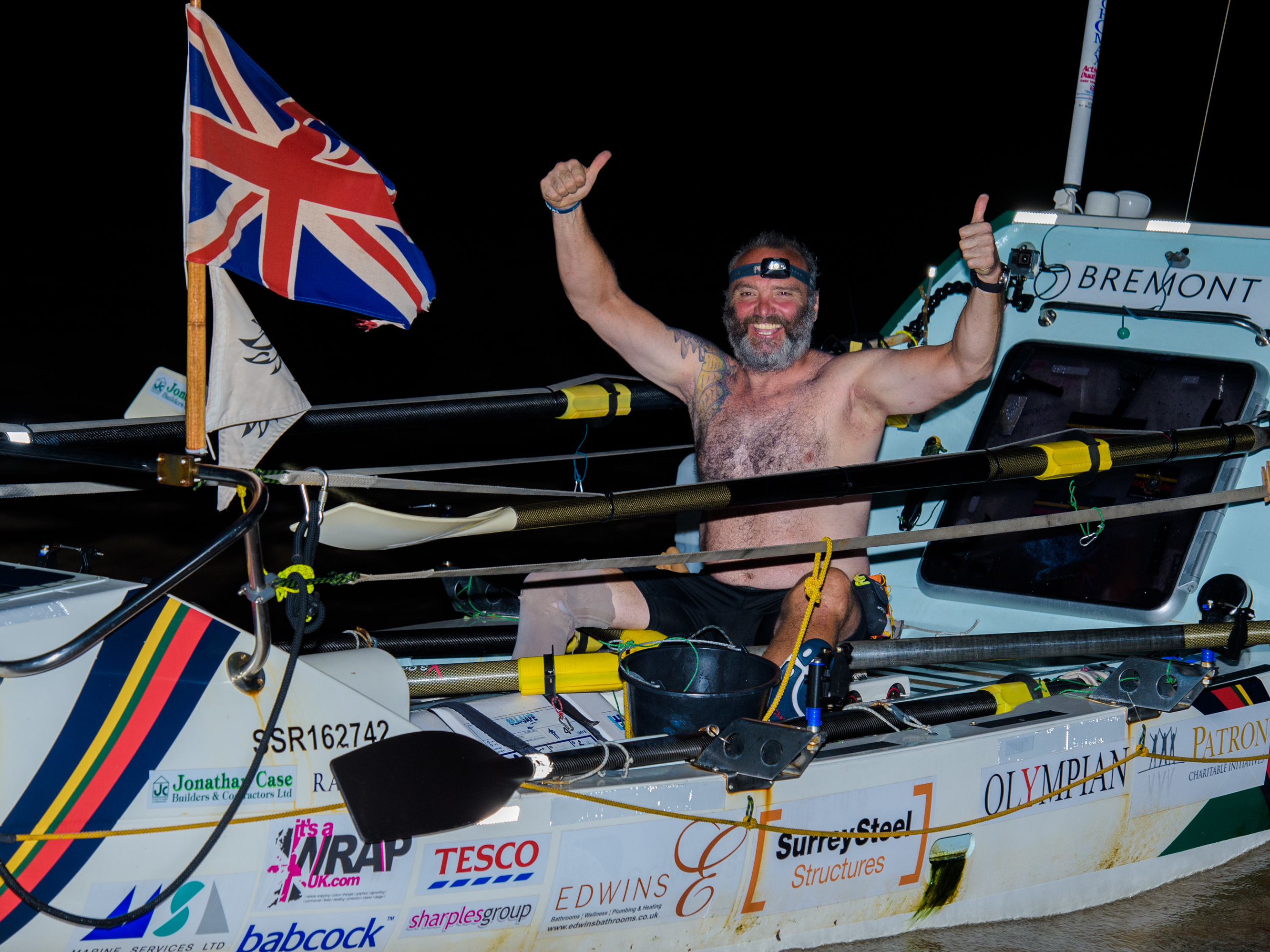 caption: Lee Spencer, a 49-year-old single-leg amputee, celebrates after rowing solo across the Atlantic.