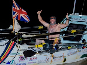 caption: Lee Spencer, a 49-year-old single-leg amputee, celebrates after rowing solo across the Atlantic.