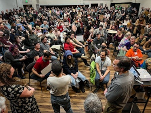 caption: Roughly 400 people packed the Martin Luther King FAME Community Center in Seattle’s Madison Valley on Dec. 7, 2023, to discuss a proposal for a playground structure at Denny Blaine Park. The proposal was ultimately struck down.

