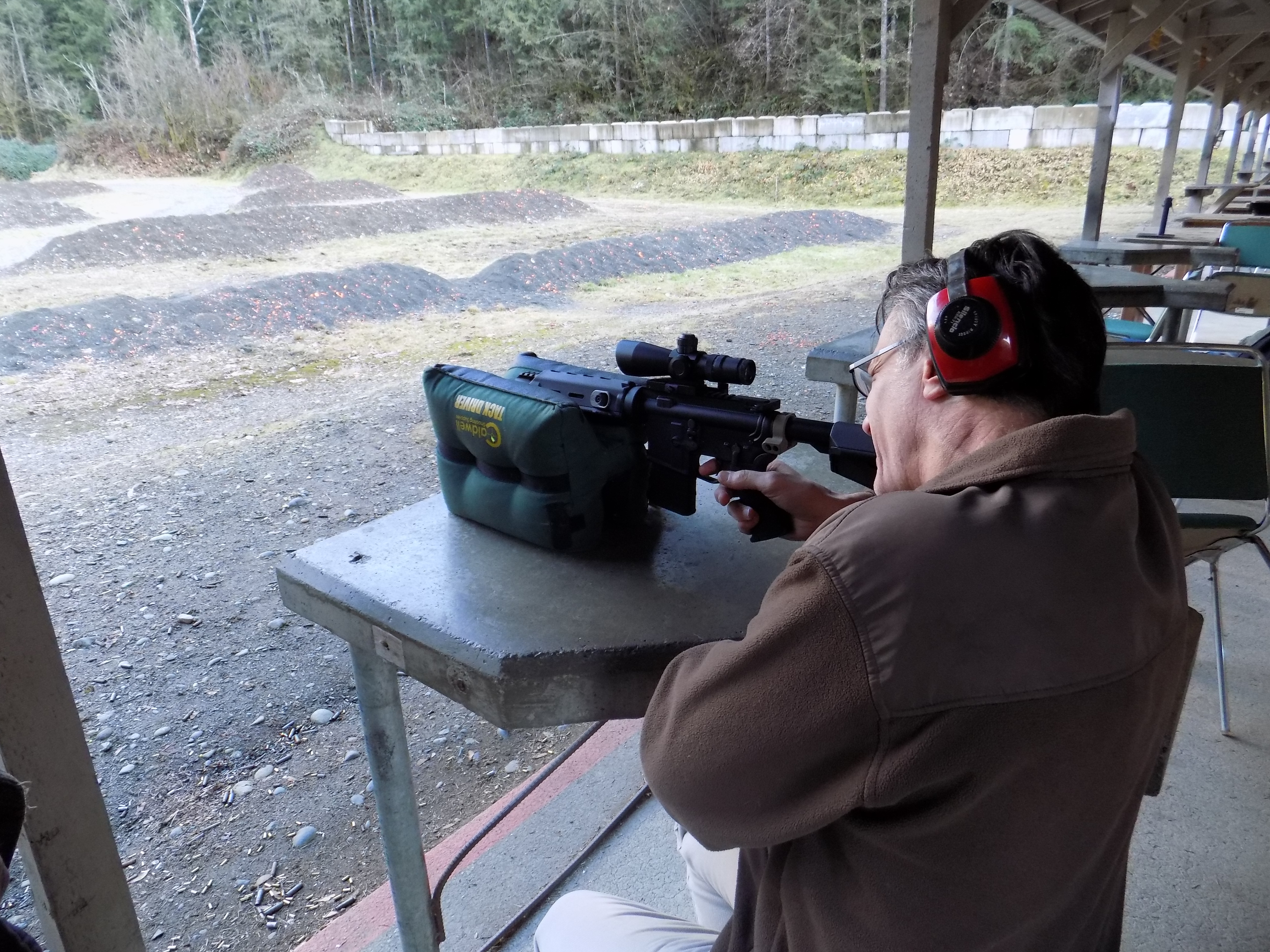 caption: KUOW host Bill Radke visits a gun range and learns how to shoot a sem-automatic weapon.