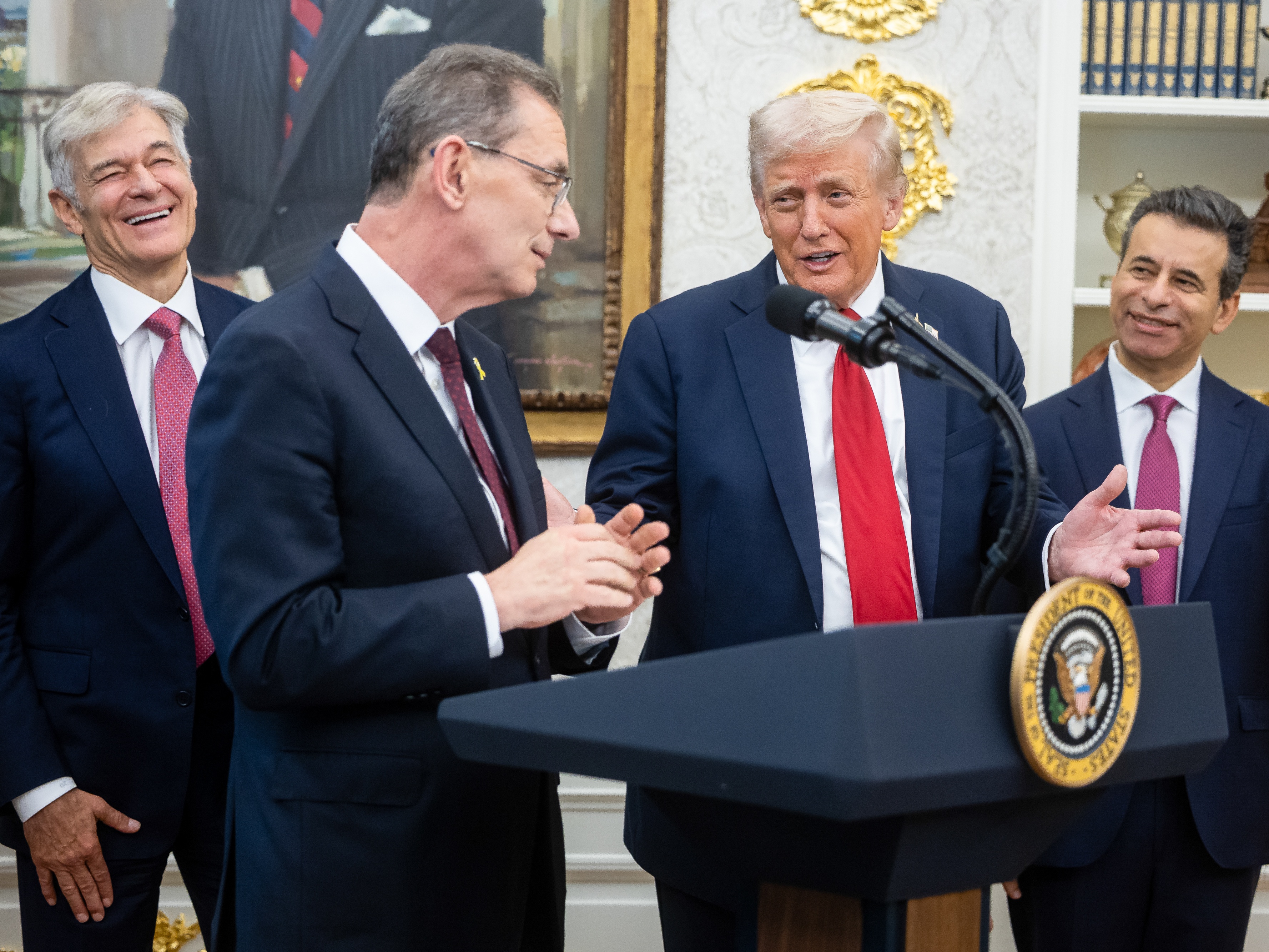 caption: Mehmet Oz, administrator of the Centers for Medicare &amp; Medicaid Services, (from left), Albert Bourla, CEO of Pfizer, President Trump, and Martin Makary, commissioner of the Food and Drug Administration, discuss a drug price initiative in the Oval Office Tuesday.