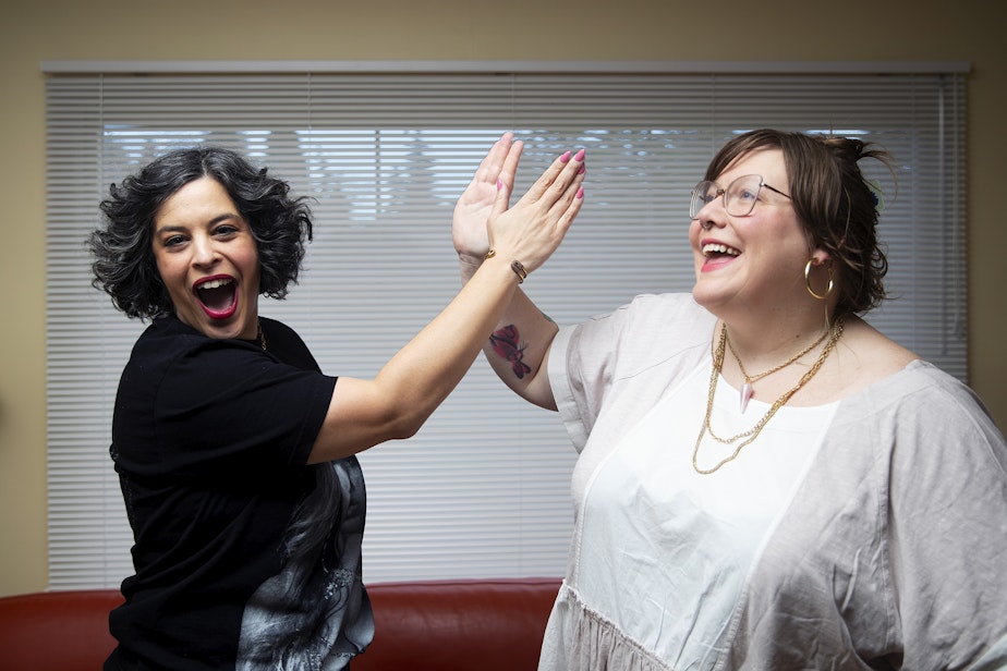 caption: Hosts of Text Me Back, Meagan Hatcher-Mays, left, and Lindy West, right, high-five each other while being portrayed on Friday, February 16, 2024, in Seattle. 