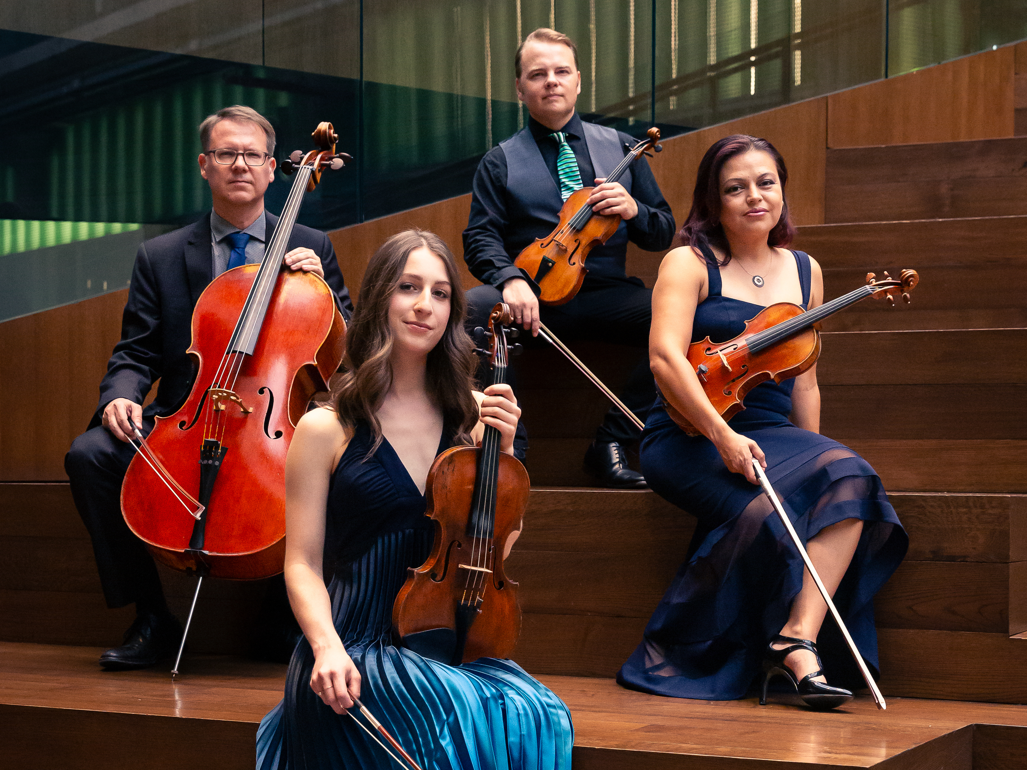 caption: The Apollo Chamber Players create concerts in response to book banning, the refugee crisis, the war in Gaza and other world events. The members of the Houston based ensemble are Matthew Dudzik, left, Aria Cheregosha, Matthew J. Detrick and Anabel Ramírez.