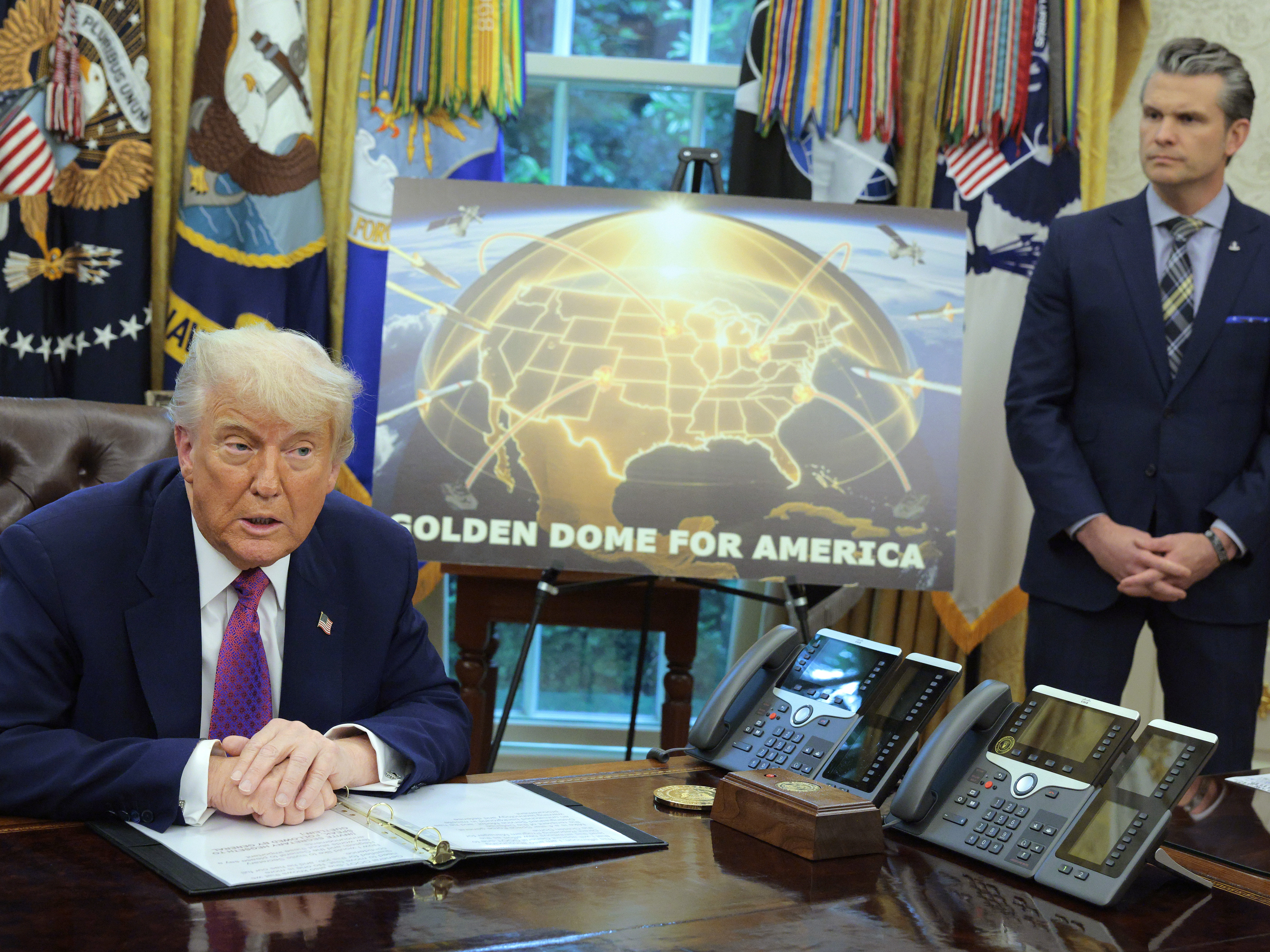 caption: President Trump speaks alongside Secretary of Defense Pete Hegseth in the Oval Office on May 20, 2025, announcing plans for the "Golden Dome," a national ballistic and cruise missile defense system.