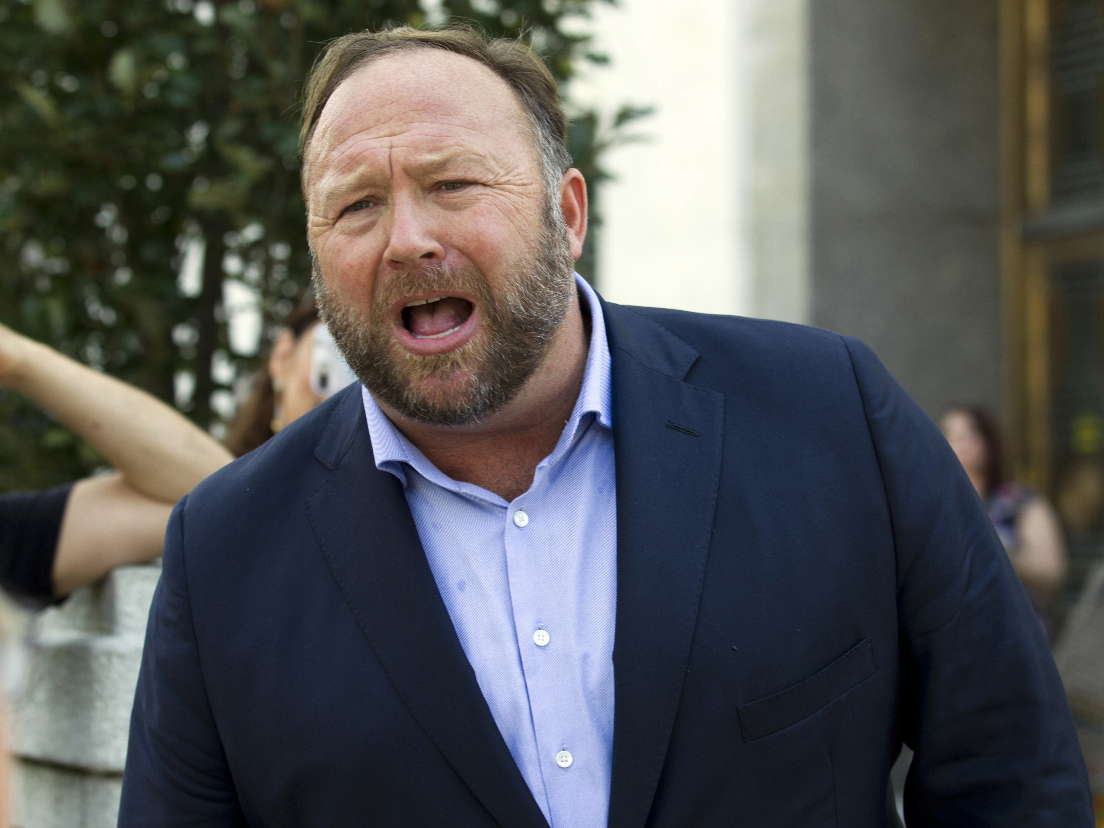 caption: Alex Jones, host of Infowars, is pictured on Capitol Hill in Washington in September 2018. Jones defied a Connecticut judge's order to show up for a deposition in Texas on Thursday in a case brought by relatives of victims of the Sandy Hook Elementary School shooting.