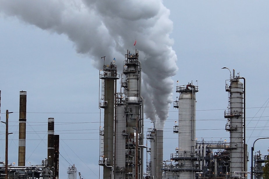 caption: Steam and invisible, heat-trapping carbon dioxide spew from a Shell oil refinery in Anacortes, Washington.