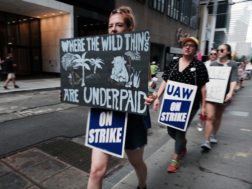 caption: Employees of HarperCollins Publisher participate in a one-day strike outside the publishing houses offices in Manhattan on July 20, 2022 in New York City.