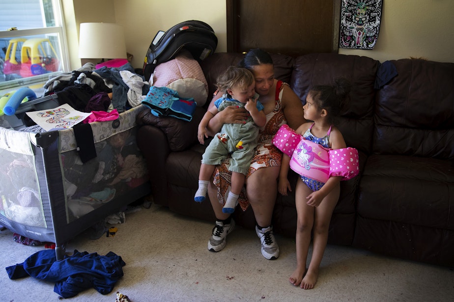 caption: Tynikki Arnold sits with her 1-year-old son Messiah, and 5-year-old daughter, Vay, at their apartment in Lynnwood on Friday, July 15, 2022.