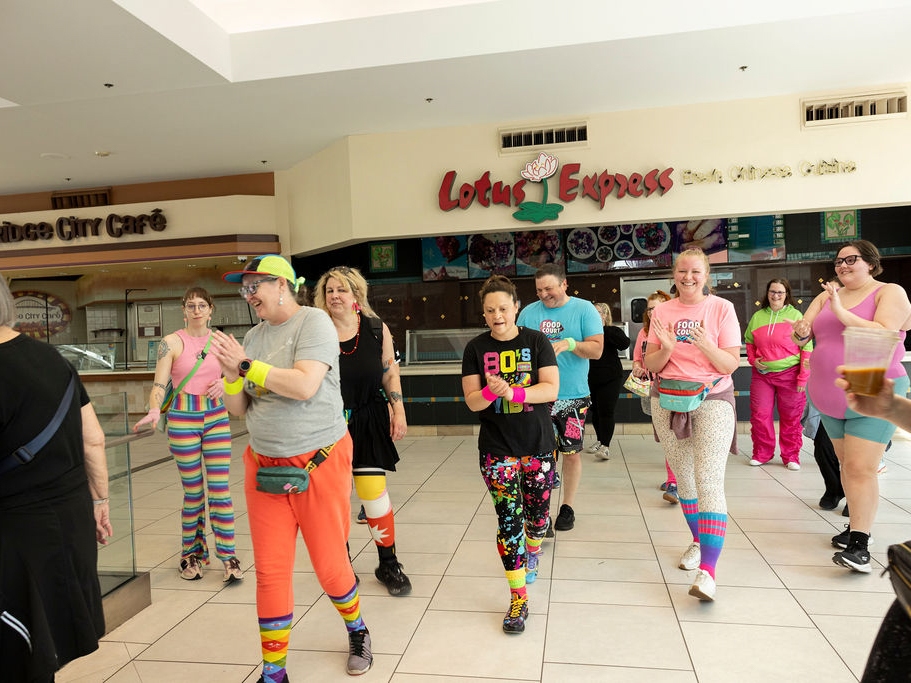 caption: Food Court 5000 participants loop along each floor of the Lloyd Center twice for their Sunday walk on April 26 in Portland, Ore.